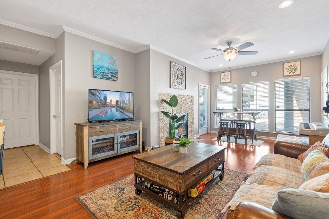 a living room with furniture a flat screen tv and a fireplace
