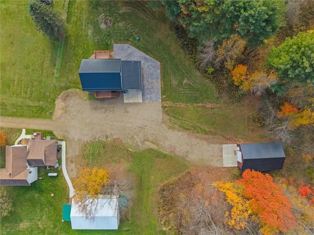 a backyard of a house with table and chairs
