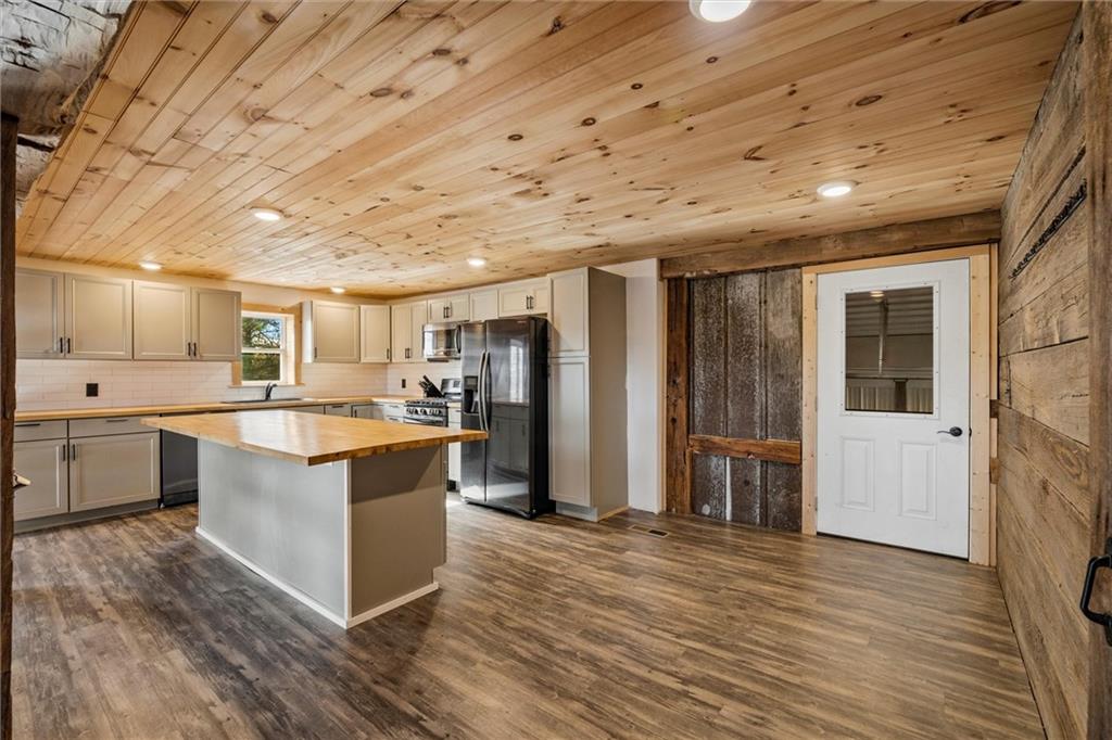10019 Dingman Road Guys Mills, PA 16327 - Photo 5 of 50 a large kitchen with a large counter top a sink stainless steel appliances and cabinets