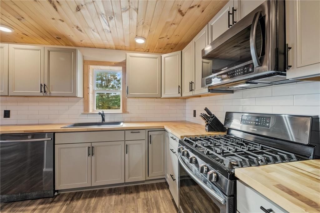 10019 Dingman Road Guys Mills, PA 16327 - Photo 9 of 50 a kitchen with a stove a sink and a microwave