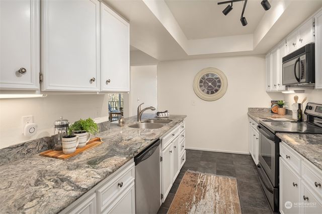 a kitchen with a sink stove and cabinets