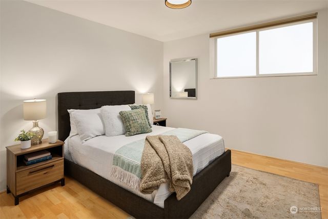 a bed room with a bed and a night stand