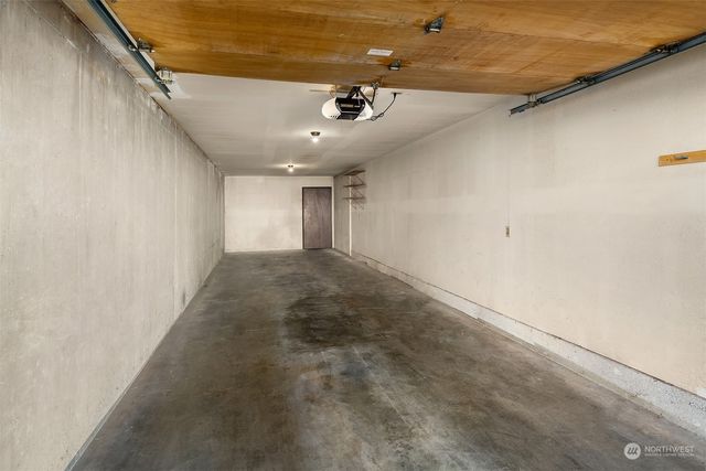 a view of a hallway with a ceiling fan