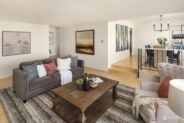 a living room with furniture a rug and a table