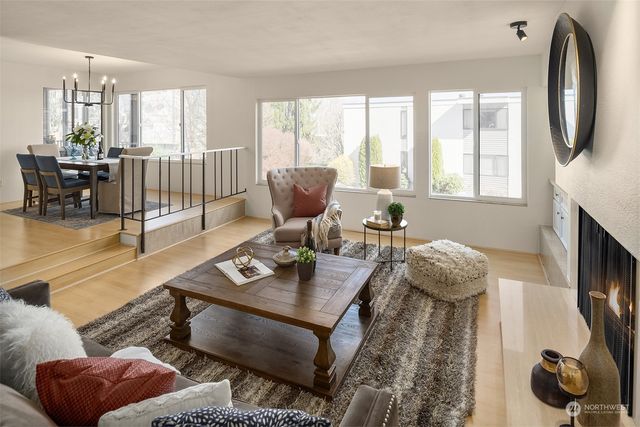 a living room with furniture and a floor to ceiling window