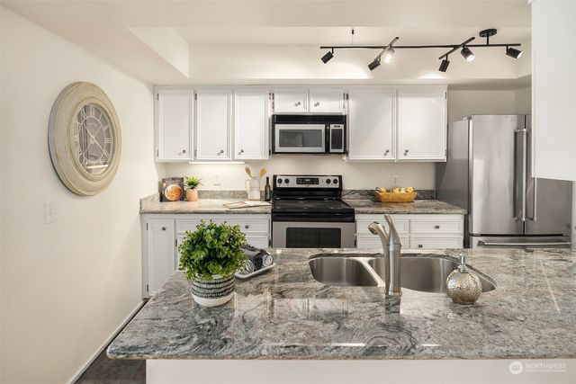a kitchen with a sink and a stove top oven