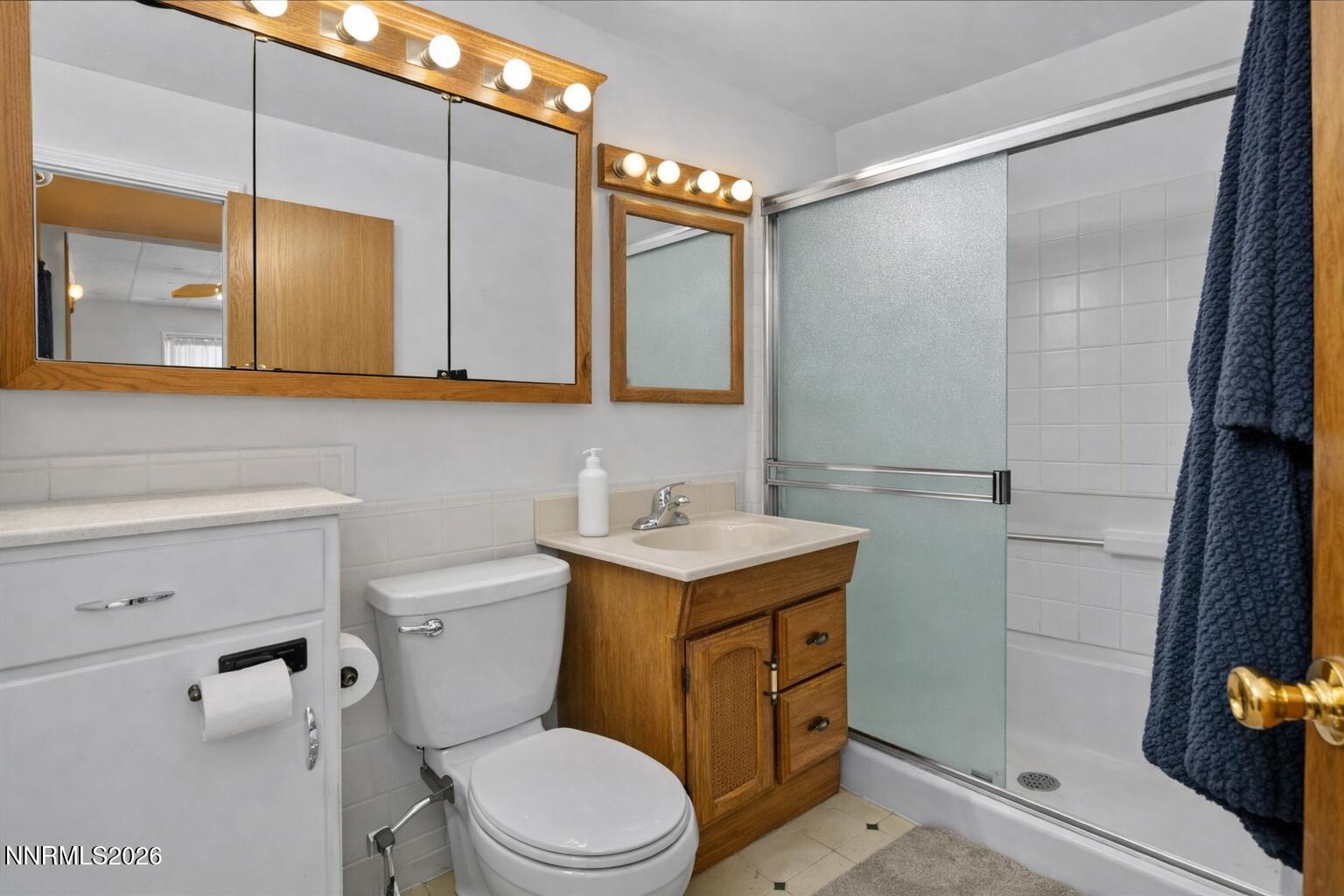 1945 4th Street, Unit 3 Sparks, NV 89431 - Photo 13 of 20 a bathroom with a sink a toilet a mirror and shower