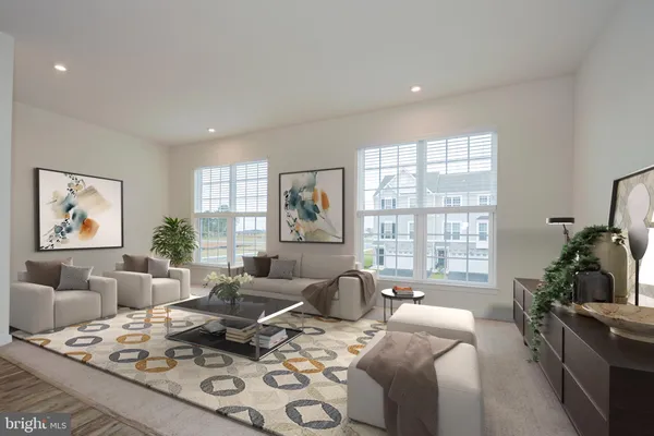 a living room with furniture couches and a large window