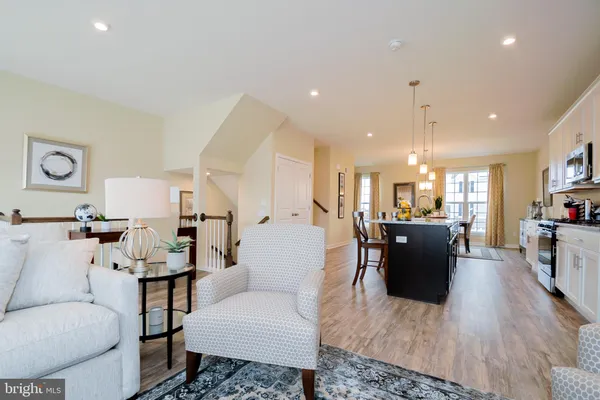 a living room with furniture and kitchen view