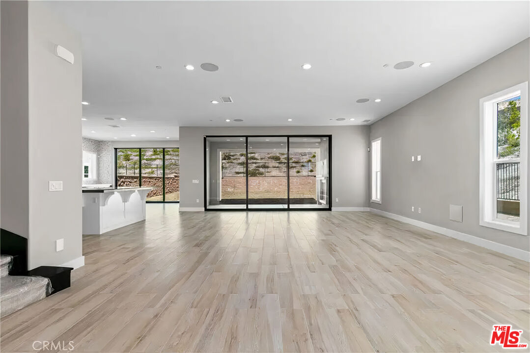20517 Deer Grass Court Porter Ranch, CA 91326 - Photo 13 of 75 an empty room with wooden floor and windows