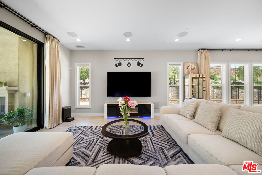 20517 Deer Grass Court Porter Ranch, CA 91326 - Photo 16 of 75 a living room with furniture and a flat screen tv