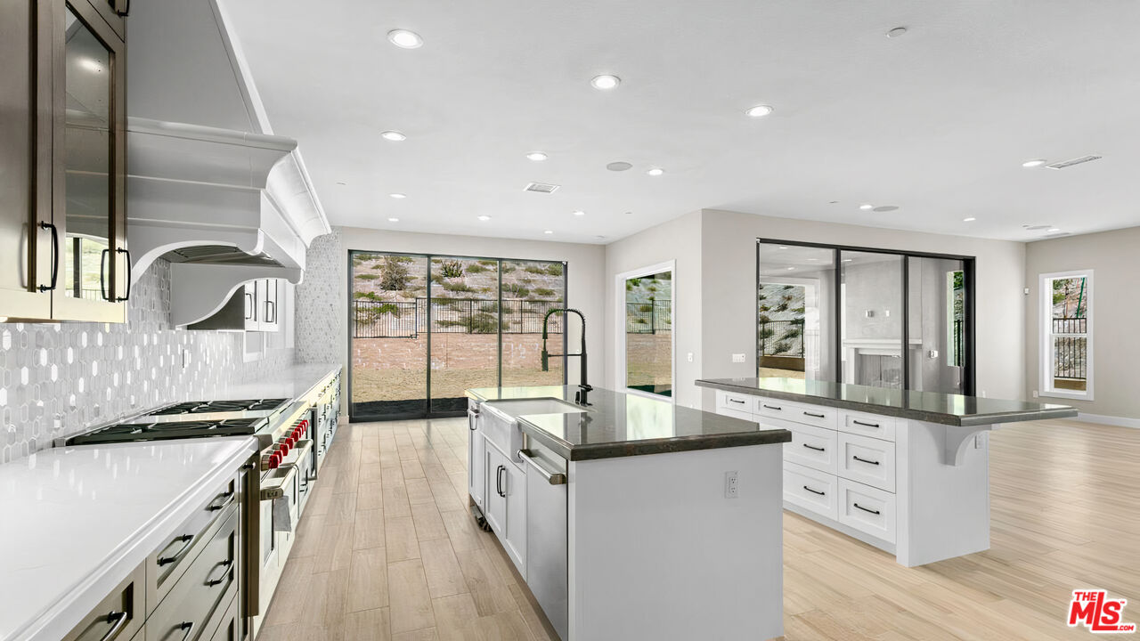 20517 Deer Grass Court Porter Ranch, CA 91326 - Photo 23 of 75 a kitchen with counter top space a sink and appliances