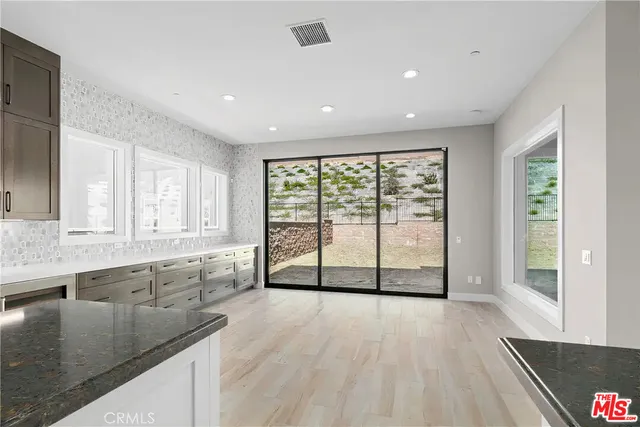 a view of a room with a wooden floor