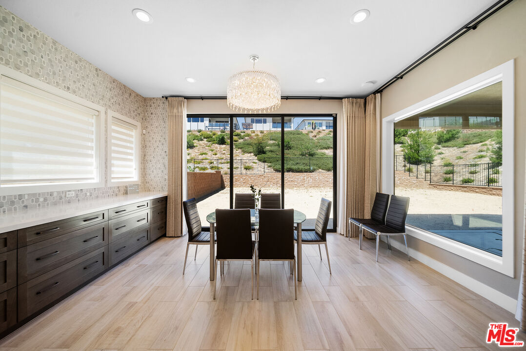 20517 Deer Grass Court Porter Ranch, CA 91326 - Photo 29 of 75 a view of a dining room with furniture window and wooden floor