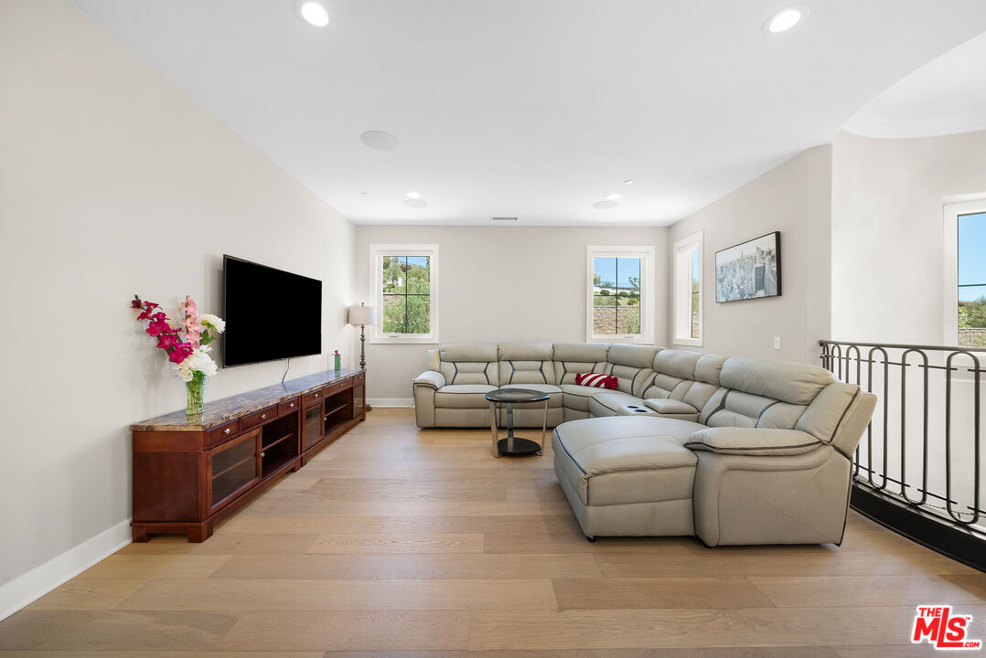 20517 Deer Grass Court Porter Ranch, CA 91326 - Photo 40 of 75 a living room with furniture and a flat screen tv
