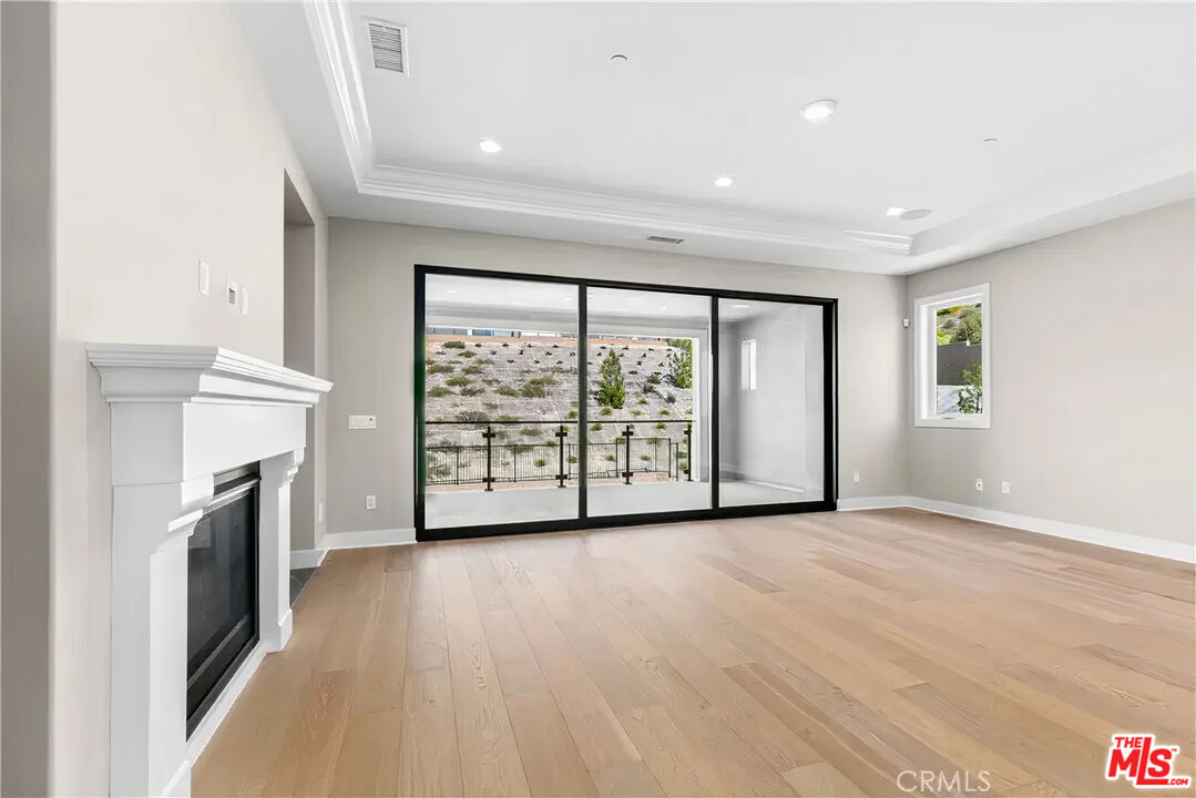20517 Deer Grass Court Porter Ranch, CA 91326 - Photo 43 of 75 a view of an empty room with a fireplace and a window