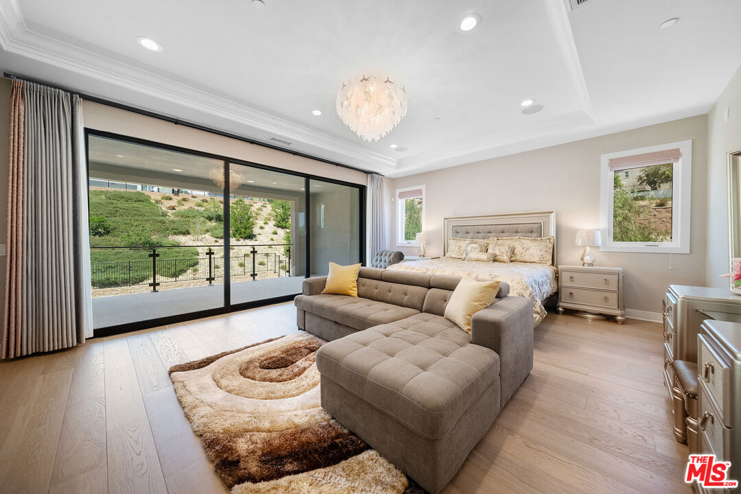 20517 Deer Grass Court Porter Ranch, CA 91326 - Photo 46 of 75 a bedroom with furniture and a large window