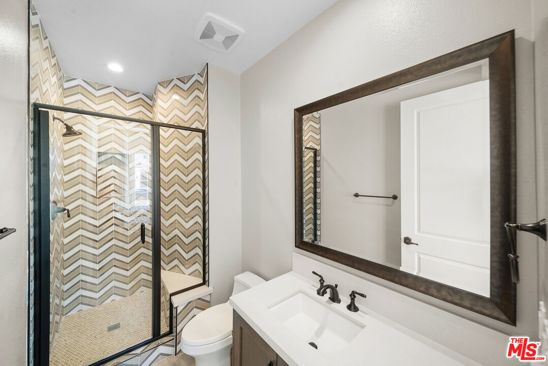 20517 Deer Grass Court Porter Ranch, CA 91326 - Photo 54 of 75 a bathroom with a sink a toilet and shower