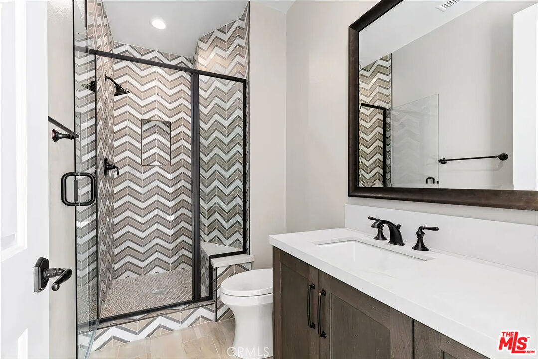 20517 Deer Grass Court Porter Ranch, CA 91326 - Photo 55 of 75 a bathroom with a sink and a mirror