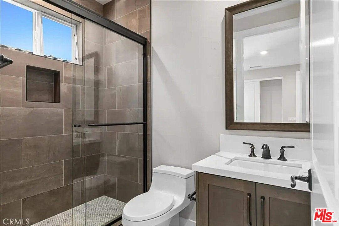 20517 Deer Grass Court Porter Ranch, CA 91326 - Photo 60 of 75 a bathroom with a sink a toilet and shower