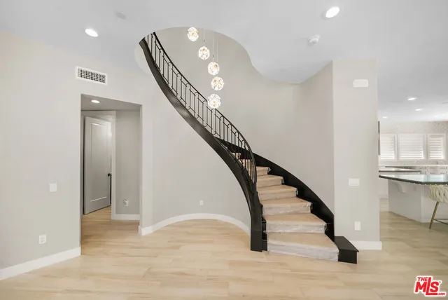 a living room with furniture a flat screen tv and a large window