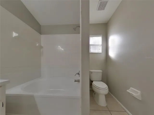 a bathroom with a toilet and shower