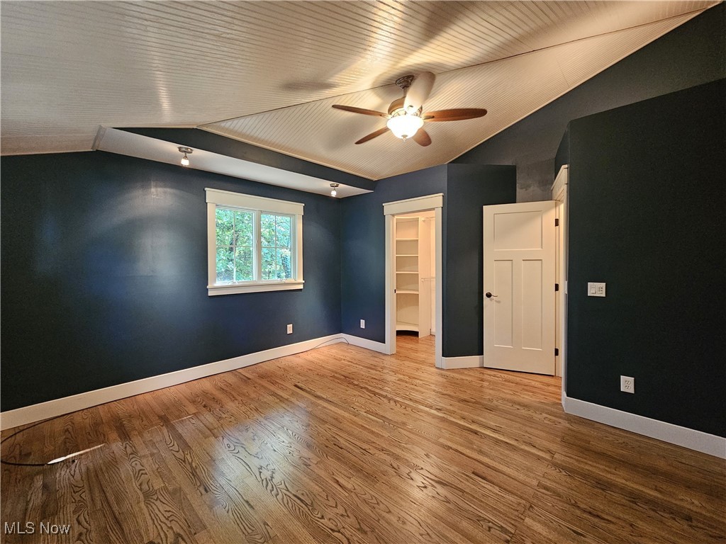 6155 Beach Road Wadsworth, OH 44281 - Photo 21 of 49 Master bedroom with a walk-in closet, lofted ceiling, hardwood flooring, and ceiling fan