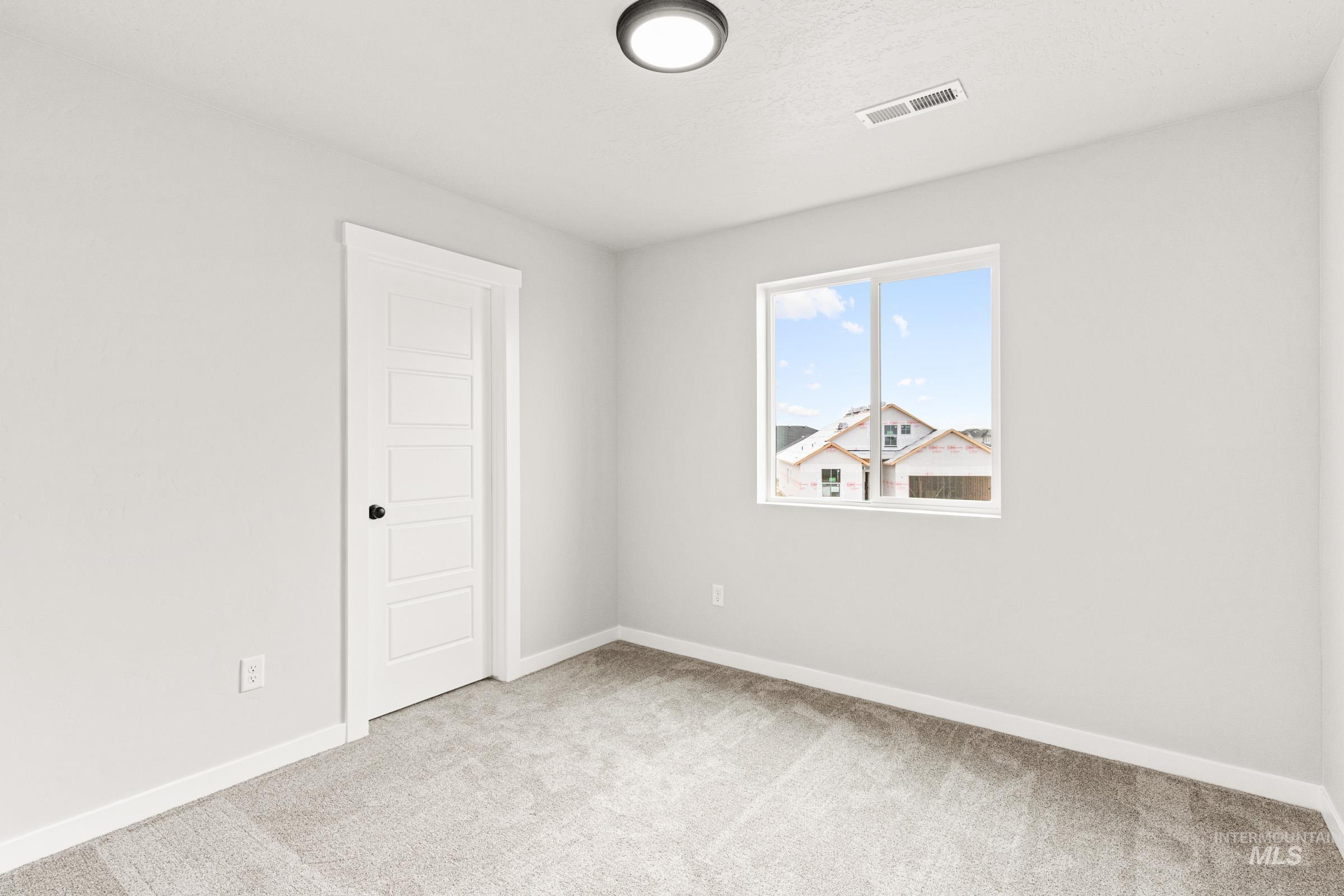 12830 Ropers Street Nampa, ID 83651 - Photo 18 of 18 Bright interior space featuring light-colored walls and carpet flooring
