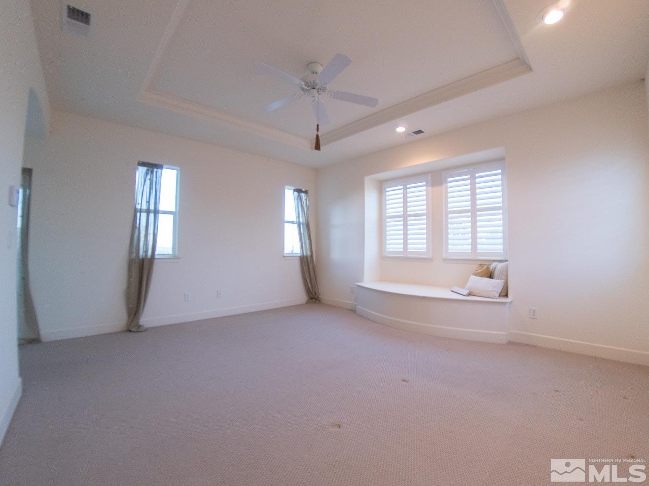 609 Rabbit Ridge Court Reno, NV 89511 - Photo 18 of 30 an empty room with windows and ceiling fan