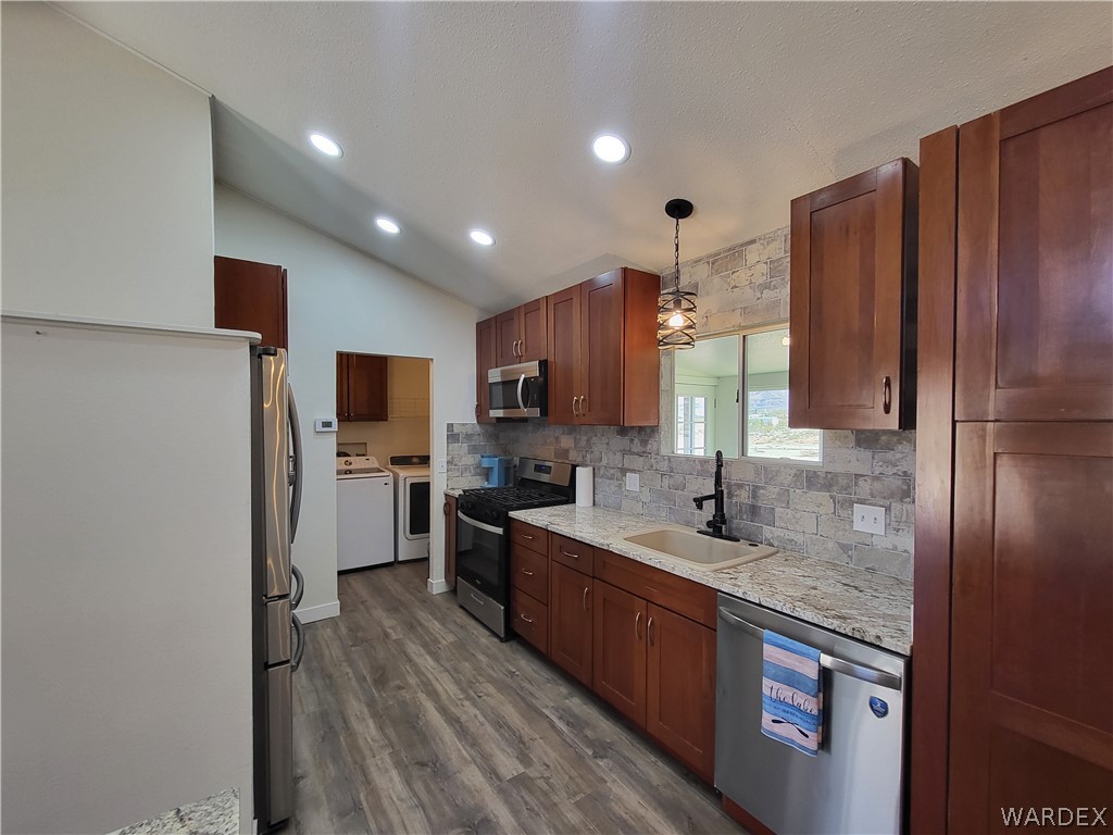 30260 Haystack Drive Meadview, AZ 86444 - Photo 13 of 52 a kitchen with stainless steel appliances granite countertop a sink stove and refrigerator