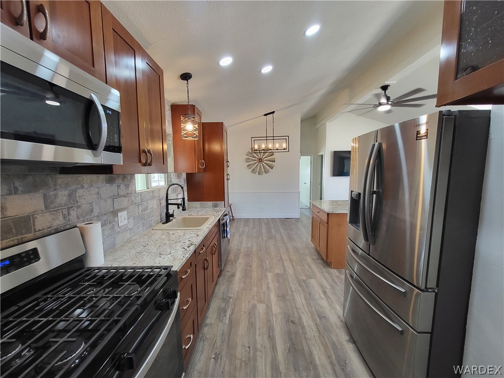 30260 Haystack Drive Meadview, AZ 86444 - Photo 14 of 52 a kitchen with stainless steel appliances granite countertop a refrigerator and a stove top oven