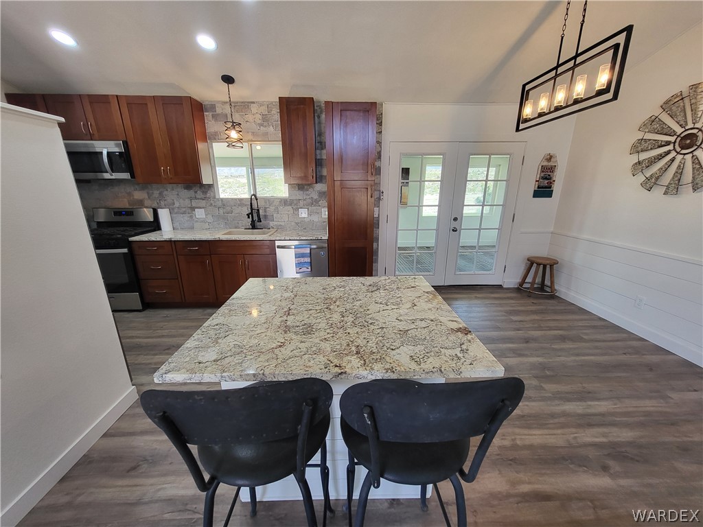 30260 Haystack Drive Meadview, AZ 86444 - Photo 15 of 52 a large kitchen with stainless steel appliances granite countertop wooden cabinets a refrigerator and a sink