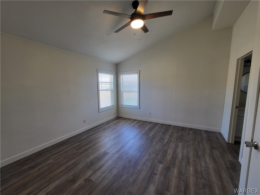 30260 Haystack Drive Meadview, AZ 86444 - Photo 16 of 52 an empty room with wooden floor and windows