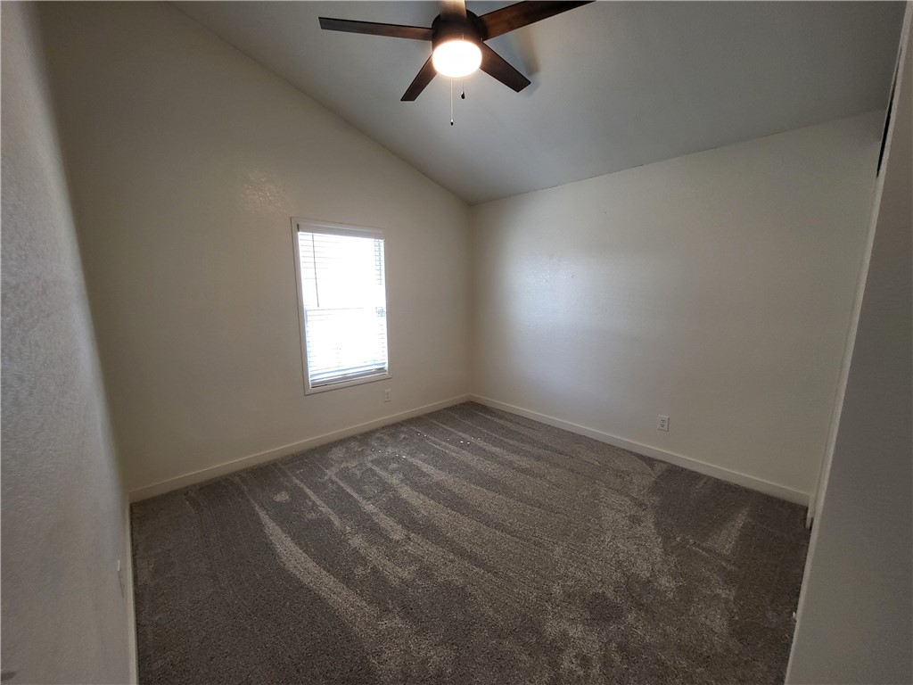 30260 Haystack Drive Meadview, AZ 86444 - Photo 24 of 52 an empty room with a chandelier fan and windows