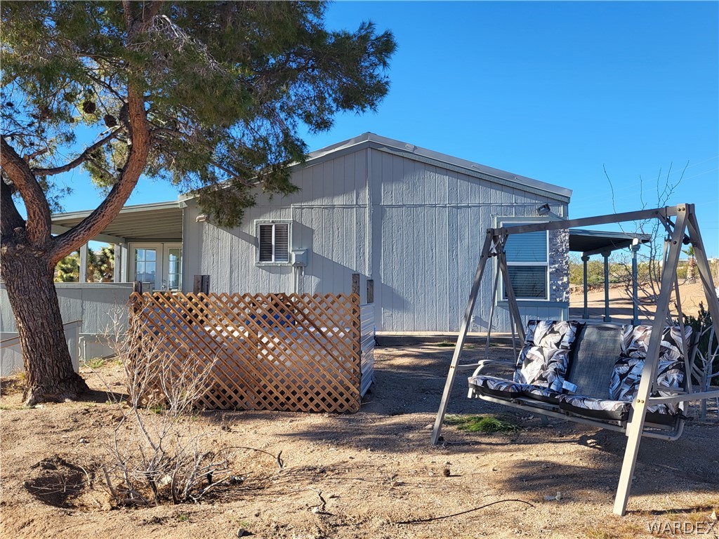 30260 Haystack Drive Meadview, AZ 86444 - Photo 37 of 52 a wooden bench sitting in front of a house