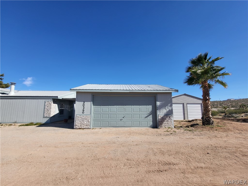 30260 Haystack Drive Meadview, AZ 86444 - Photo 42 of 52 a front view of a house with a yard and garage
