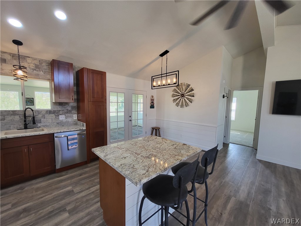 30260 Haystack Drive Meadview, AZ 86444 - Photo 9 of 52 a kitchen with stainless steel appliances granite countertop wooden floors a stove and white cabinets