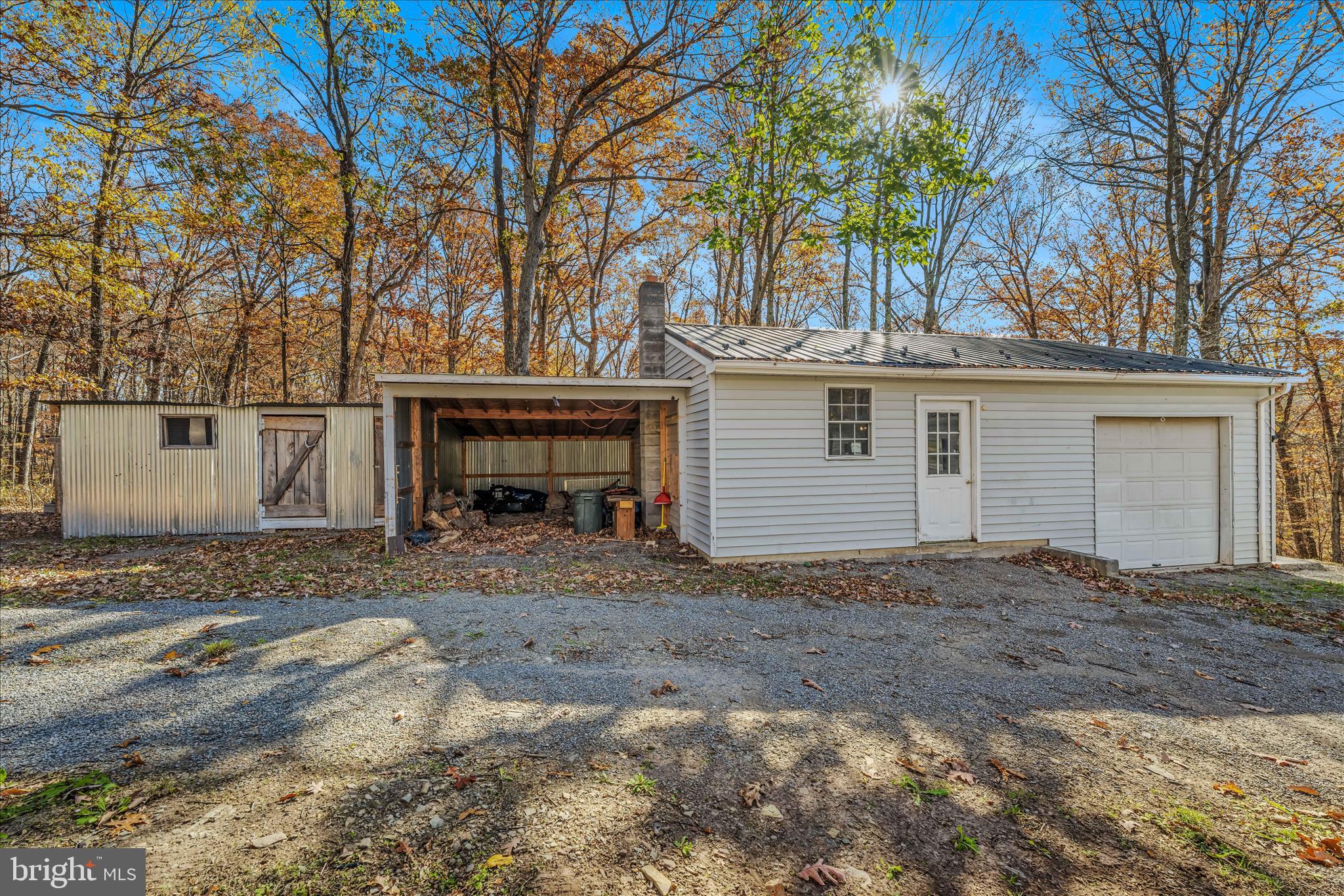 438 Gloyd Lane Great Cacapon, WV 25422 - Photo 24 of 30 a view of a house with a yard and garage