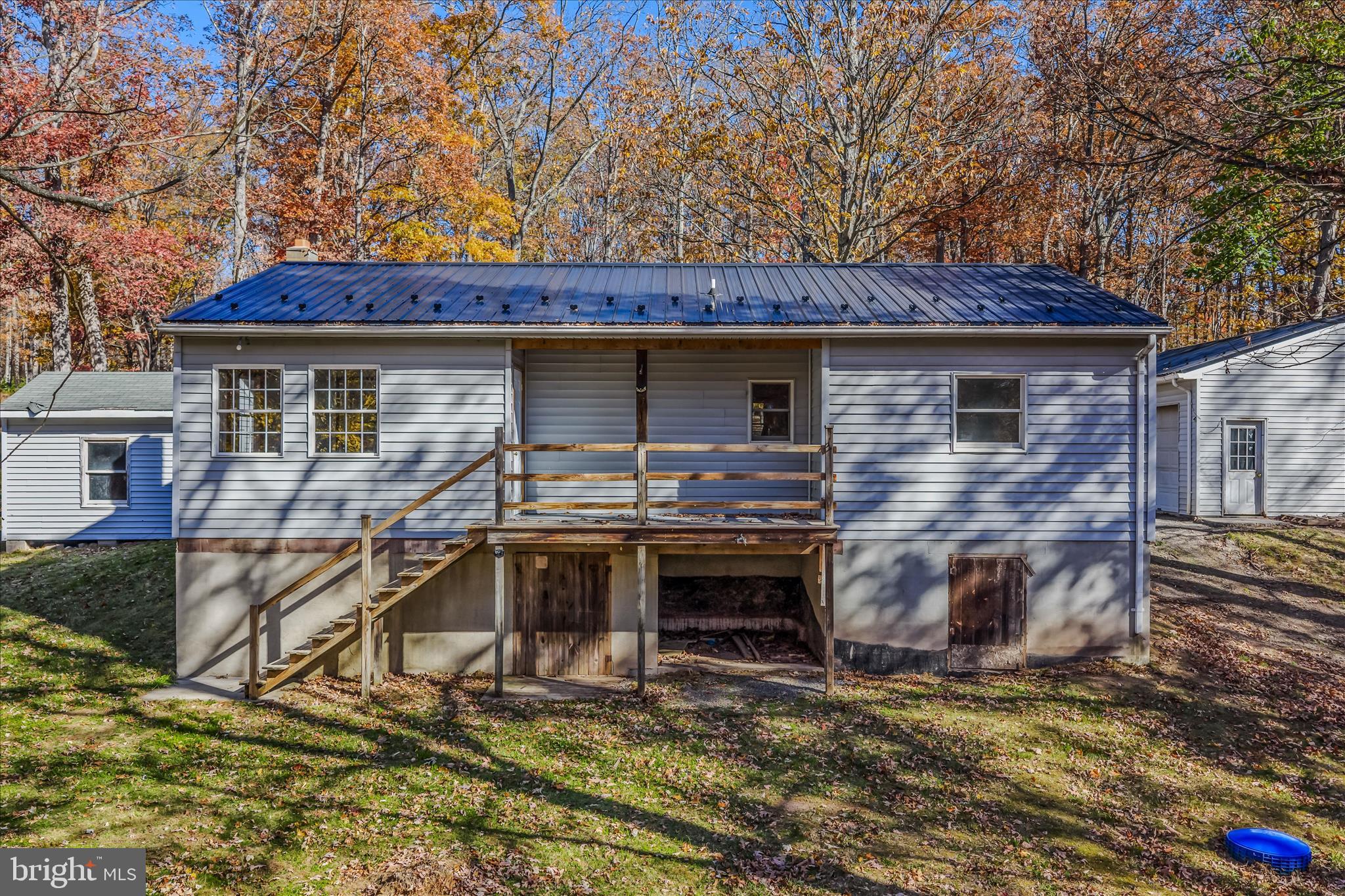 438 Gloyd Lane Great Cacapon, WV 25422 - Photo 27 of 30 a backyard of a house with barbeque oven table and chairs