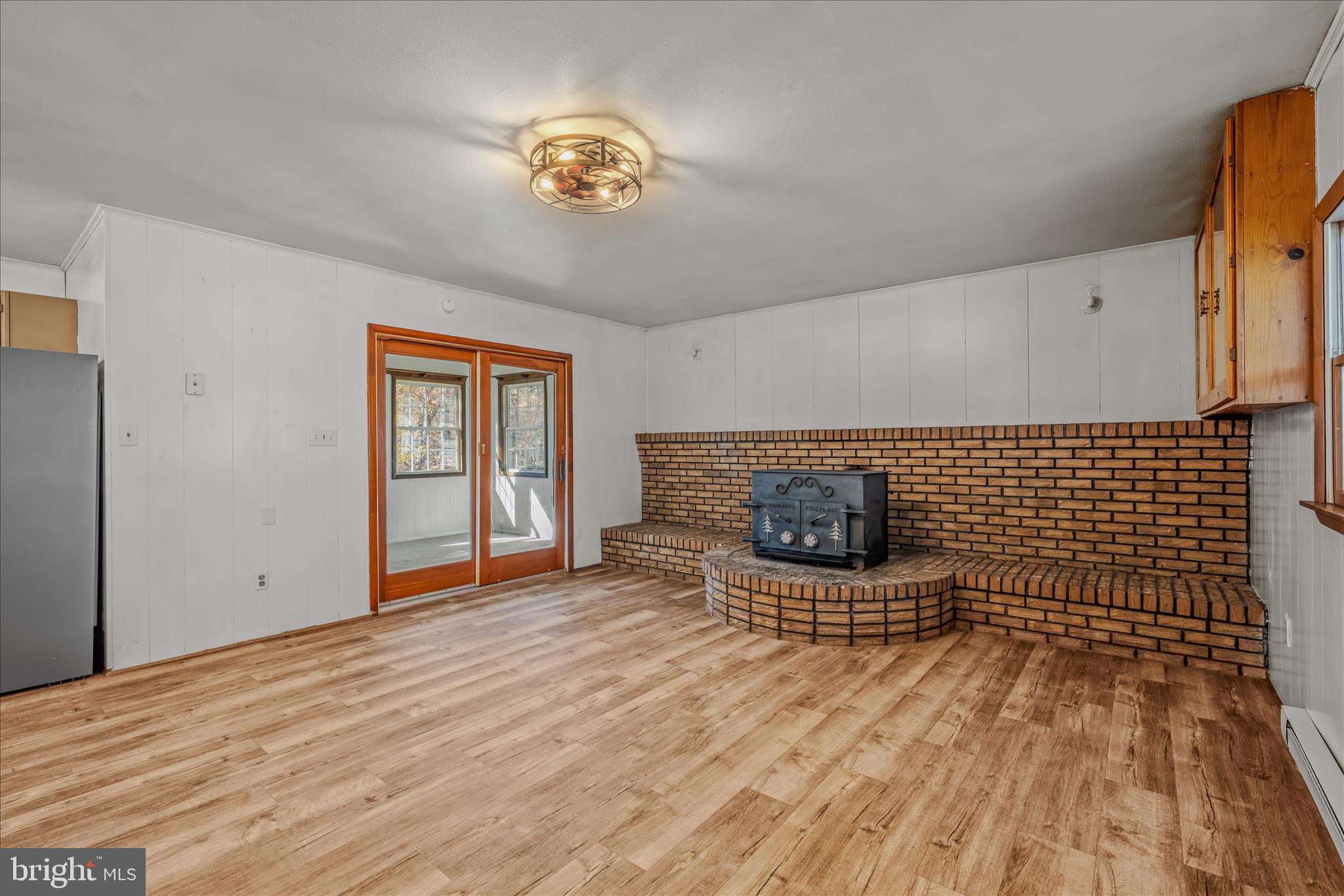438 Gloyd Lane Great Cacapon, WV 25422 - Photo 4 of 30 a view of a livingroom with wooden floor and a fireplace