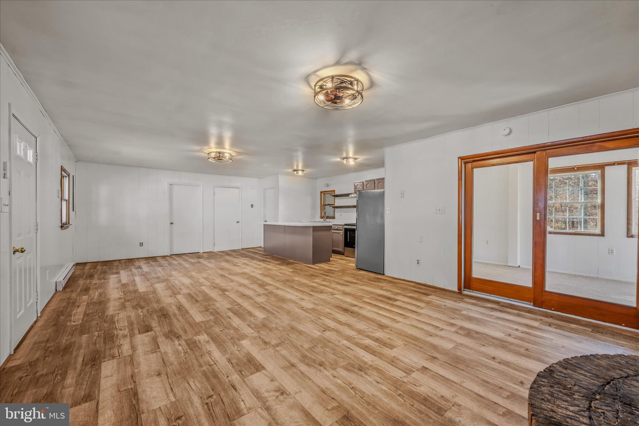 438 Gloyd Lane Great Cacapon, WV 25422 - Photo 6 of 30 a view of empty room with wooden floor and windows