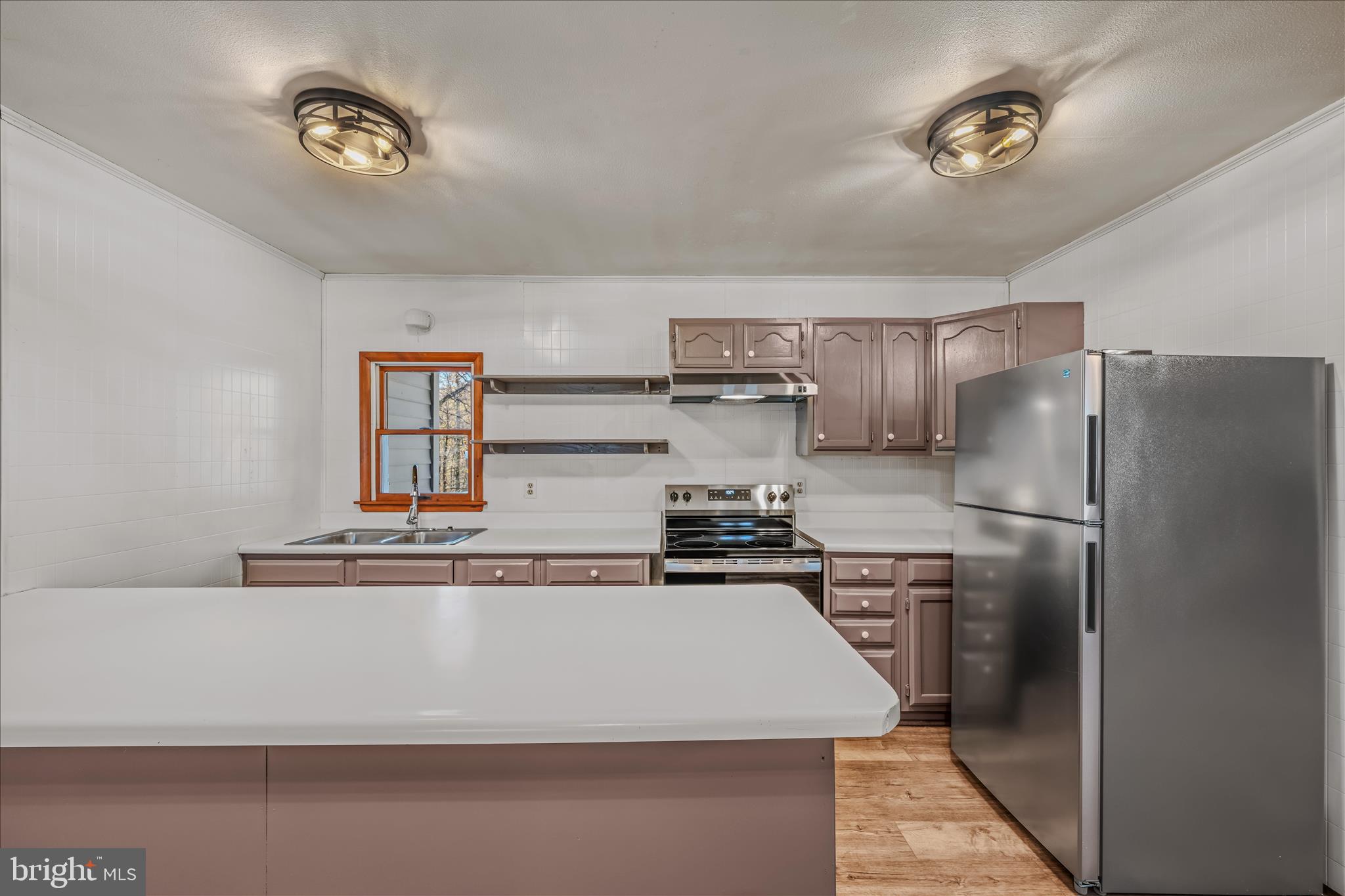 438 Gloyd Lane Great Cacapon, WV 25422 - Photo 8 of 30 a kitchen with stainless steel appliances granite countertop a refrigerator a stove and a sink