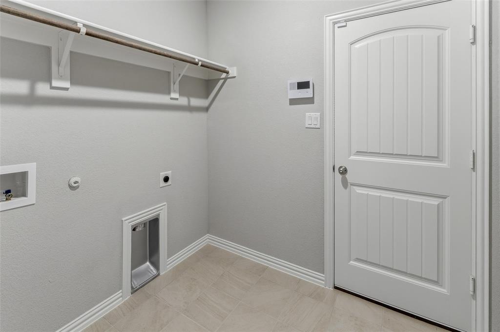 1237 Frio Drive Springtown, TX 76082 - Photo 11 of 25 Utility area featuring light-toned tile flooring, light gray walls, and white baseboards