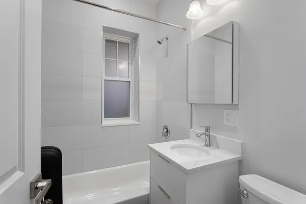 a bathroom with a toilet sink and mirror