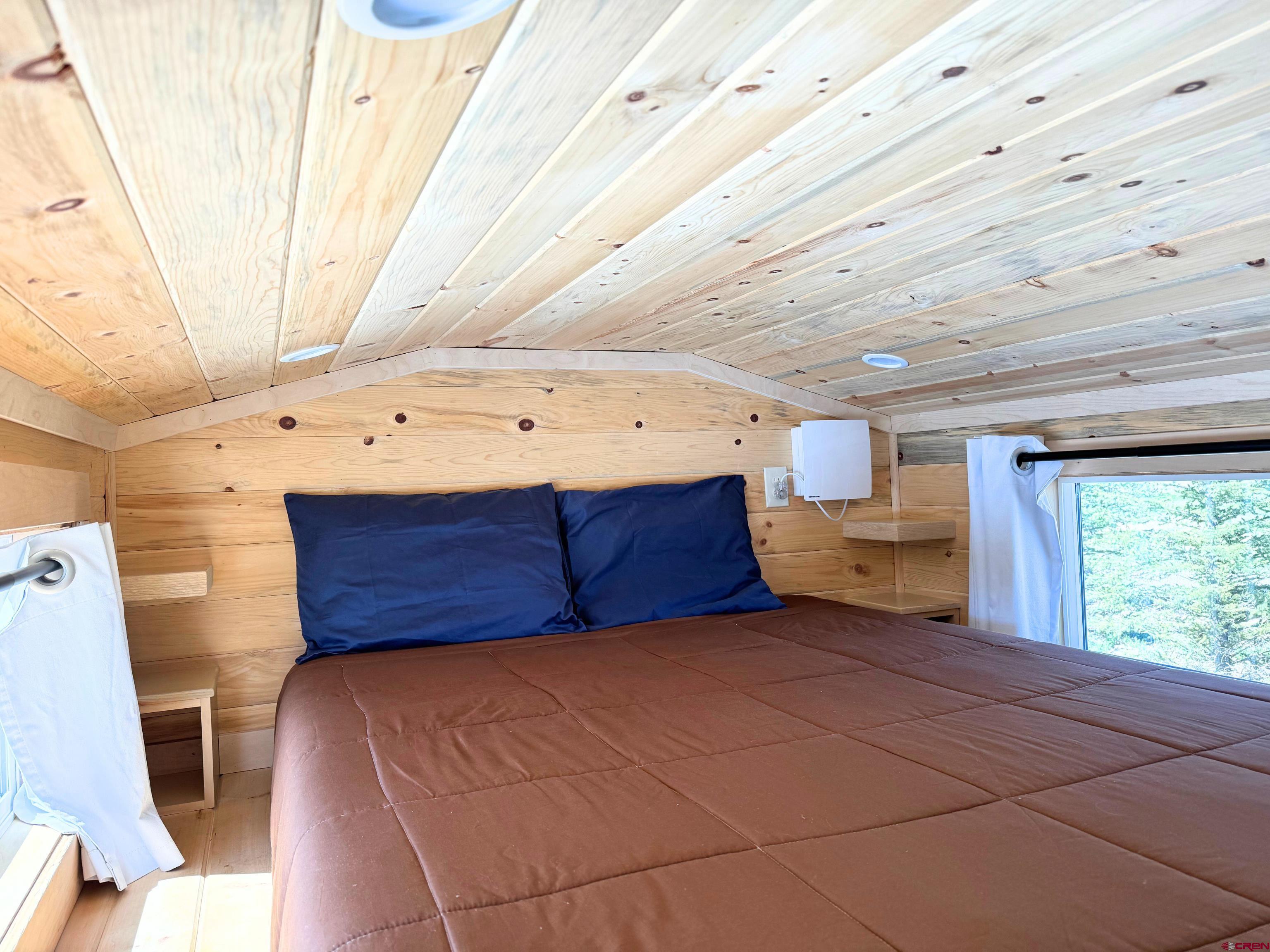 22130 6850 Road, Unit 214 Montrose, CO 81403 - Photo 13 of 26 a bedroom with a bed and a window