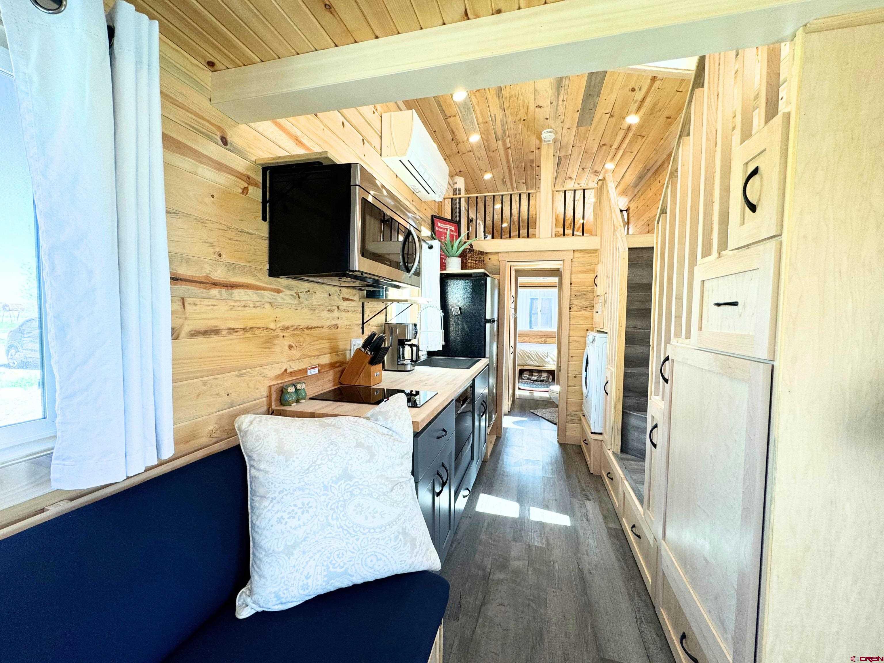 22130 6850 Road, Unit 214 Montrose, CO 81403 - Photo 4 of 26 a living room with stainless steel appliances furniture a fireplace and a large window