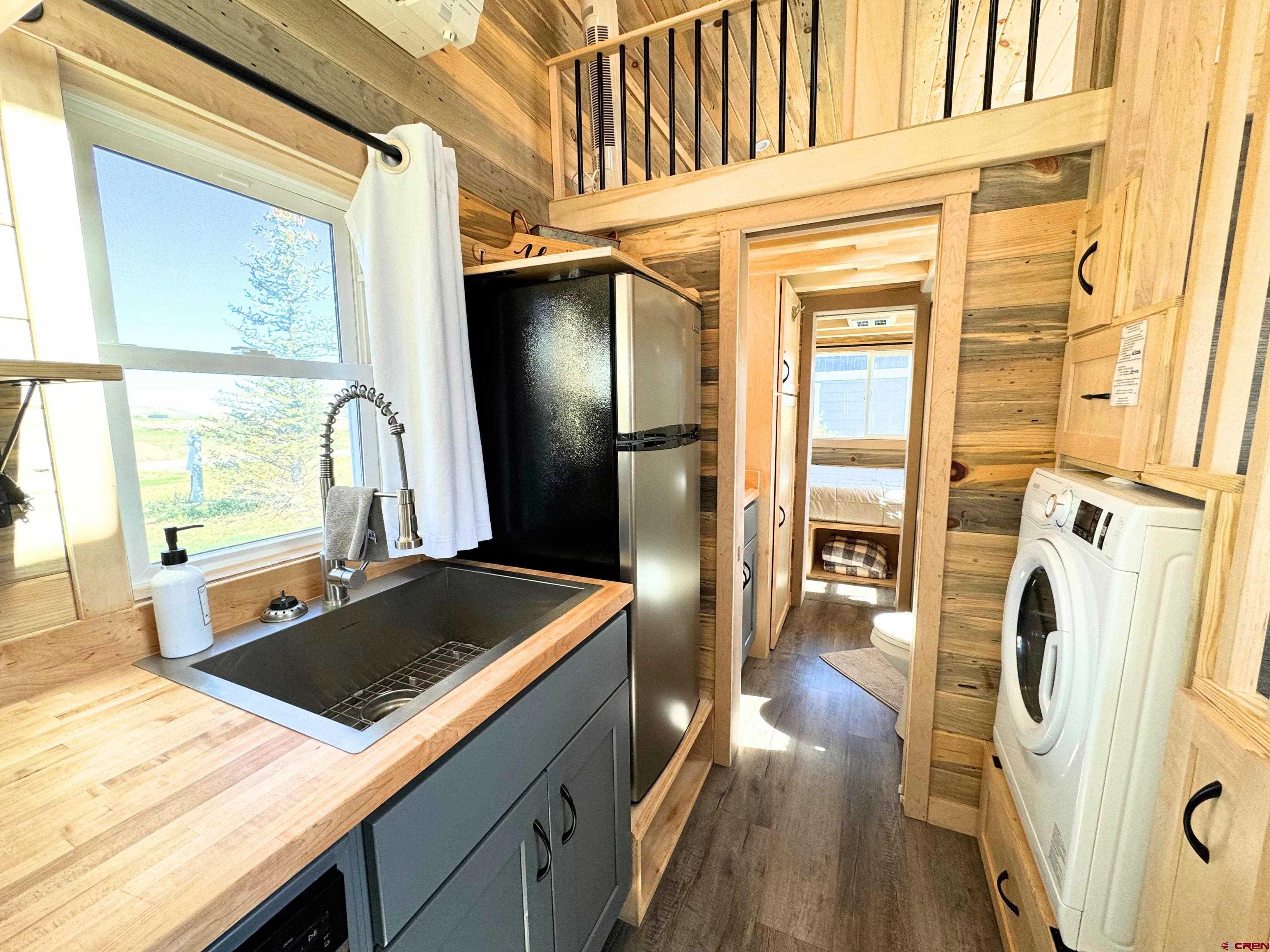 22130 6850 Road, Unit 214 Montrose, CO 81403 - Photo 5 of 26 a kitchen with refrigerator and window