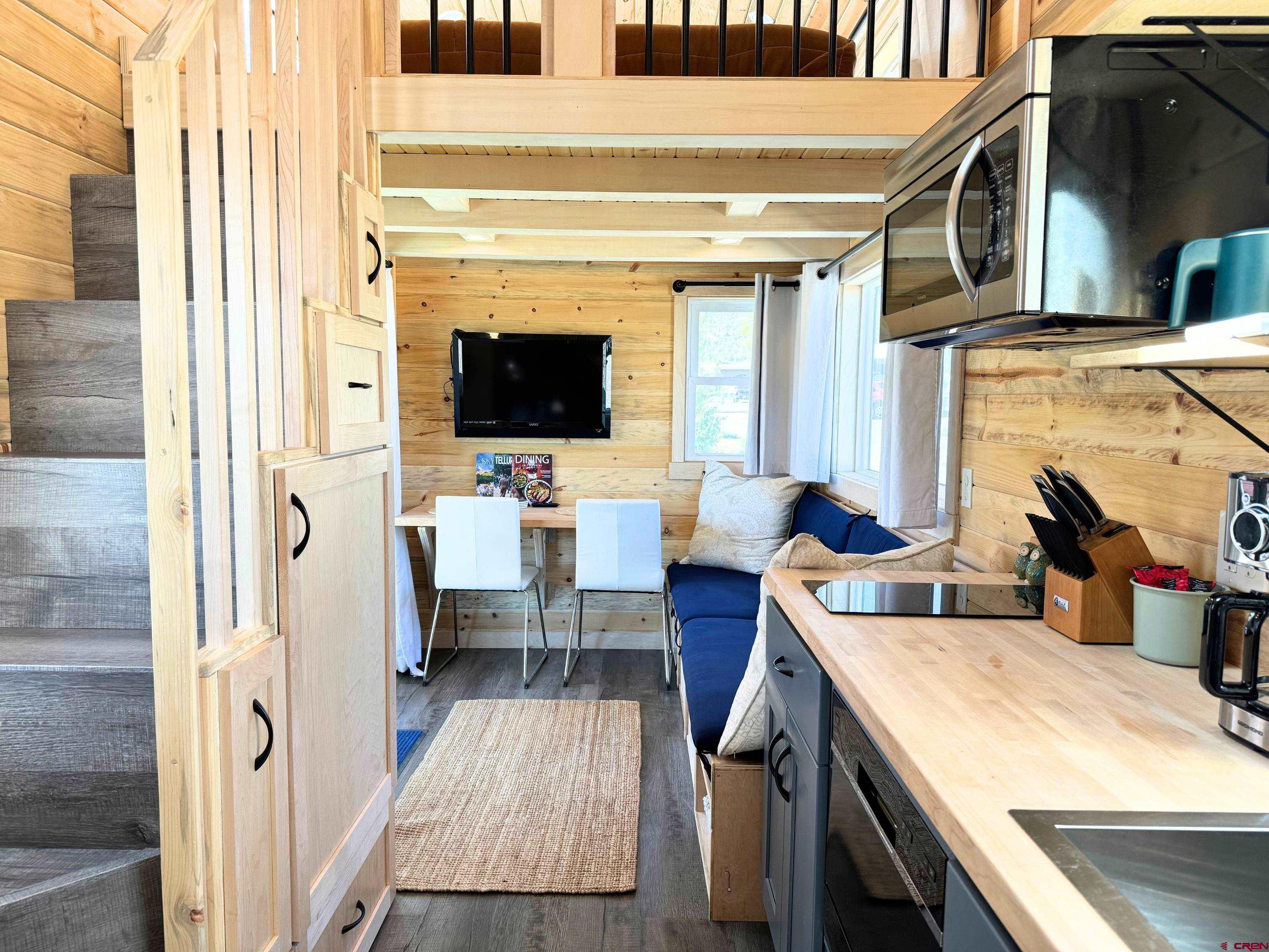 22130 6850 Road, Unit 214 Montrose, CO 81403 - Photo 6 of 26 a living room with furniture and a flat screen tv