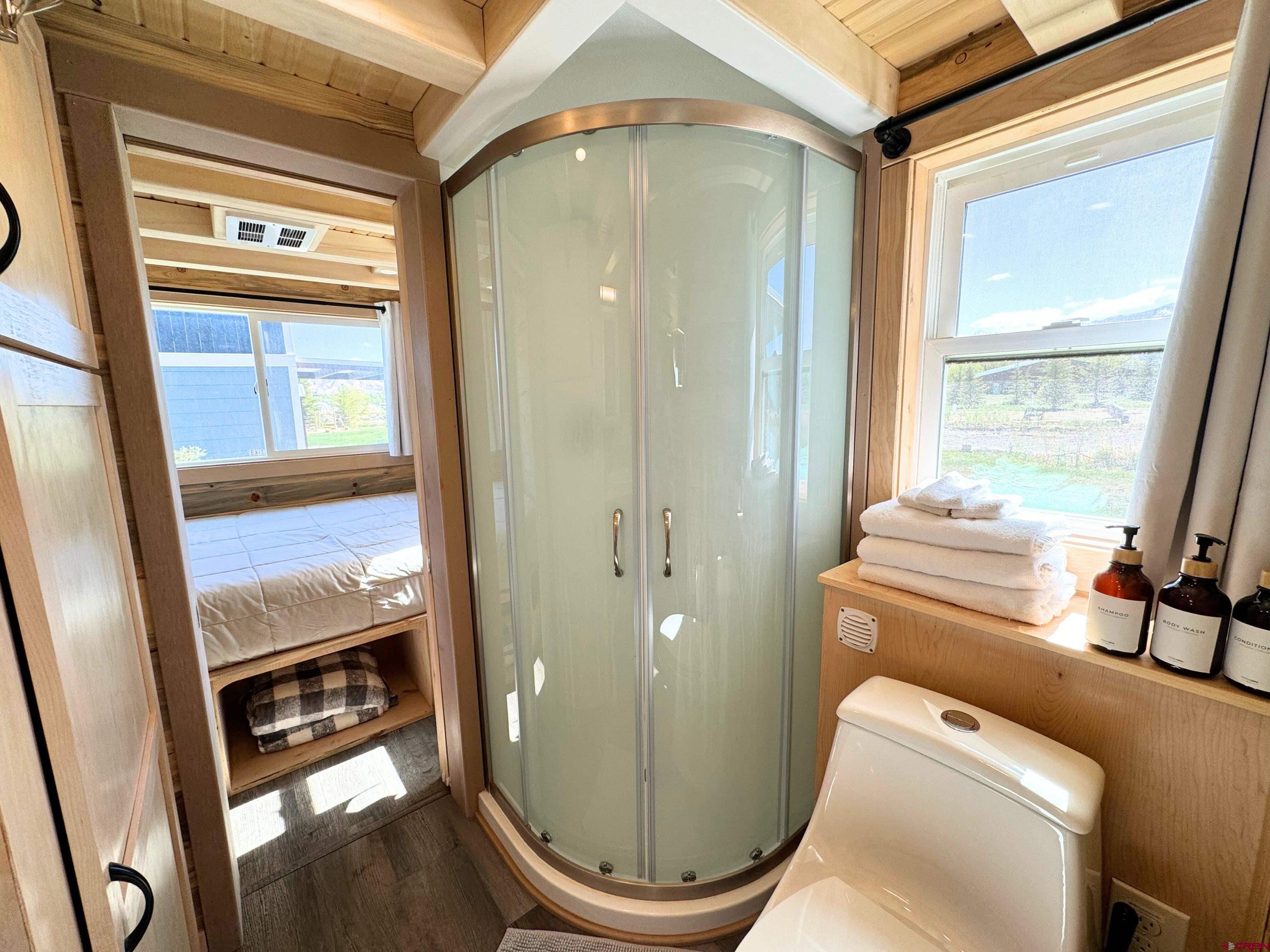 22130 6850 Road, Unit 214 Montrose, CO 81403 - Photo 8 of 26 a bathroom with a toilet a sink and a mirror