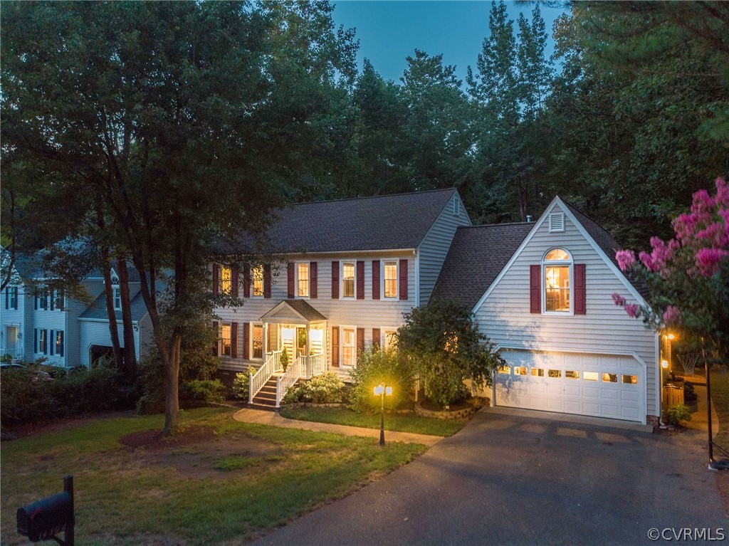 14302 Huntgate Woods Road Midlothian, VA 23112 - Photo 1 of 50 a front view of a house with a yard